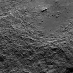 This view shows the southwestern rim of 106-mile-wide (170-kilometer-wide) Urvara crater on Ceres.In the crater's center is a prominent double peak. NASA's Dawn spacecraft obtained the image on Oct. 15, 2015.
