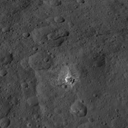 This view from NASA's Dawn spacecraft features a crater named Oxo, which is about 6 miles (9 kilometers) in diameter. A short, linear slump, where a mass of material has dropped below the surface, is seen to the left of Oxo's crater rim.