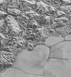 In this highest-resolution image from NASA's New Horizons spacecraft, great blocks of Pluto's water-ice crust appear jammed together in the informally named al-Idrisi mountains.