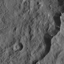 This view from NASA's Dawn spacecraft captures the southeast rim of Dantu Crater. Bright material can be seen in some places along the walls. A network of fractures in the crater floor is visible at upper right.