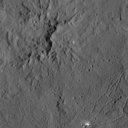 This view from NASA's captured by NASA's Dawn spacecraft on Dec. 21,2015, shows the central complex of mountain peaks within Dantu Crater on Ceres. A patch of bright material is visible near lower right.