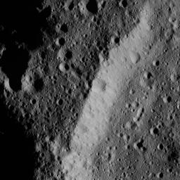 This image, taken by NASA's Dawn spacecraft, shows the heavily cratered rim of an older, unnamed impact feature on Ceres. The crater density is almost the same inside and outside, and its wall is also quite battered by impacts.