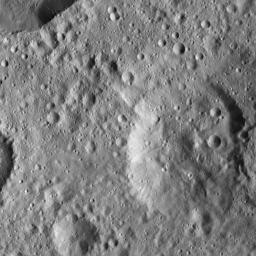 This view from NASA's Dawn spacecraft shows the Cerean terrain. The crater in the upper left corner displays smooth, relatively crater-free walls and small spurs of compacted material.