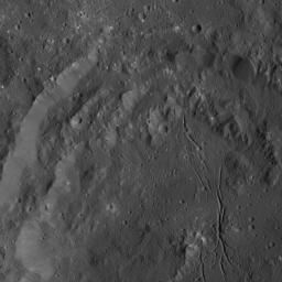 NASA's Dawn spacecraft obtained this view of Azacca Crater on Ceres. The rim of this crater has terraces descending from its rim down to its floor. The crater's floor is relatively free of large impact scars and is named for the Haitian god of agriculture
