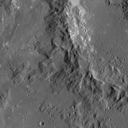 This image, taken by NASA's Dawn spacecraft, shows mountainous terrain along the rim of Ikapati Crater, located in the northern hemisphere of Ceres. The scene is lightly cratered, mostly by small impacts.