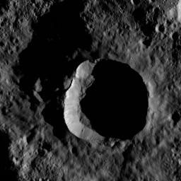 This view from NASA's Dawn spacecraft shows an impact site at high southern latitude on Ceres. A smooth blanket of ejecta surrounds the crater. Many boulders can be seen around the crater's rim and on the sunlit part of its floor.