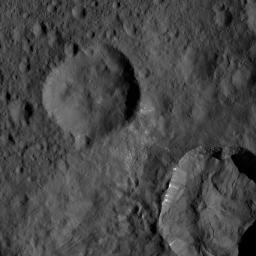 This view from NASA's Dawn spacecraft shows an area in mid-southern latitudes on Ceres. The crater named Juling (12 miles, 20 kilometers wide) is seen at lower right. Bright material is visible along its upper walls.