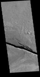 This image captured by NASA's 2001 Mars Odyssey spacecraft shows a portion of Cerberus Fossae, a set of linear graben located south of Tartarus Montes.
