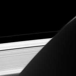 Captured by NASA's Cassini spacecraft, Saturn's A and F rings appear bizarrely warped where they intersect the planet's limb, whose atmosphere acts here like a very big lens.