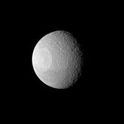 Tethys, one of Saturn's larger icy moons, vaguely resembles an eyeball staring off into space in this view from NASA's Cassini spacecraft. The resemblance is due to the enormous crater, Odysseus, and its complex of central peaks.