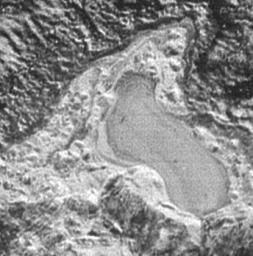 NASA's New Horizons spacecraft captured this feature which appears to be a frozen, former lake of liquid nitrogen, located in a mountain range just north of Pluto's informally named Sputnik Planum.