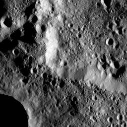 The rim of Hamori Crater on Ceres is seen in the upper right portion of this image, which was taken by NASA's Dawn spacecraft. Hamori is located in the southern hemisphere of Ceres and measures 37 miles (60 kilometers) wide.