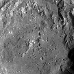 NASA's Dawn spacecraft shows Azacca Crater has a prominent set of north-south trending fractures. Its floor is relatively smooth and its rim has terraces descending toward its floor. Azacca was named for the Haitian god of agriculture.