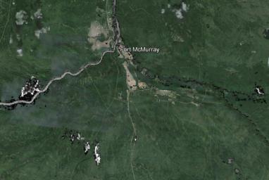 The wildfire that devastated Fort McMurray in May 13, 2016 and forced the evacuation of an additional 12,000 residents in the area is seen in this image from NASA's Terra spacecraft.