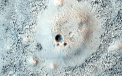 This image from NASA's Mars Reconnaissance Orbiter spacecraft shows part of a broad plain covered with cratered cones and domes in the Northern lowlands of Mars.