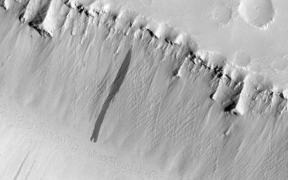The two linear depressions in this image from NASA's Mars Reconnaissance Orbiter spacecraft form part of the Elysium Fossae complex, a group of troughs located in the Elysium quadrangle of Mars.
