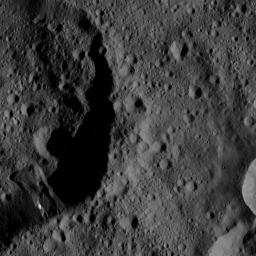 This image captured by NASA's Dawn spacecraft features the shadowy rim of an unnamed crater on Ceres. The crater on the left appears relatively old, as its flanks are rugged and the crater density inside it is more or less uniform.