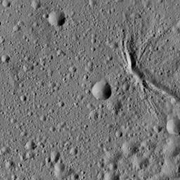 This picture from NASA's Dawn spacecraft shows a network of canyon-like features near the center of Ezinu Crater on Ceres. Ezinu measures about 72 miles (116 kilometers) in diameter and was named for the Sumerian goddess of grain