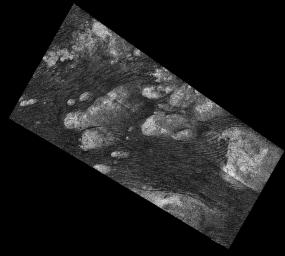 The Shangri-La Sand Sea on Titan is shown in this image from the Synthetic Aperture radar (SAR) on NASA's Cassini spacecraft. Hundreds of sand dunes are visible as dark lines snake across the surface of Titan.