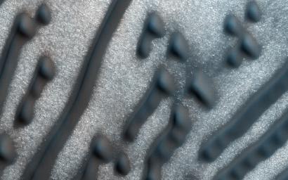 The dunes shown here, as seen by NASA's Mars Reconnaissance Orbiter spacecraft, form distinct dots and dashes. The 'dashes' are linear dunes formed by bi-directional winds, which are not traveling parallel to the dune.