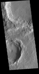 This image captured by NASA's 2001 Mars Odyssey spacecraft shows parts of two craters located at the southern end of Tempe Fossae.