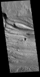 This image captured by NASA's 2001 Mars Odyssey spacecraft is located in Ravi Vallis, a channel running from the highlands of Xanthe Terra to the complex lower elevation Hydraotes Chaos.