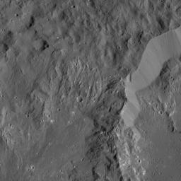 This image shows the rim of Ikapati Crater on Ceres, which lies in the dwarf planet's northern hemisphere. Groupings of roughly parallel, narrow, linear fractures can be seen inside and outside the crater.