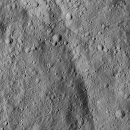 This image from NASA's Dawn spacecraft shows a portion of Homshuk Crater, left, on Ceres. This crater was named for a corn spirit originating with the Popoluca people of southern Mexico.