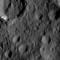 This view from NASA's Dawn spacecraft, taken on June 6, 2016, shows Takel Crater (at top left) on Ceres. Takel is 14 miles (22 kilometers) wide and exhibits streaks of bright material on its walls.