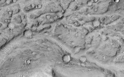 This image from NASA's Mars Reconnaissance Orbiter shows the northern terminus of an outflow channel located in the volcanic terrains of Amenthes Planum.