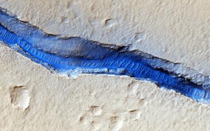 Cerberus Fossae are a series of discontinuous fissures along dusty plains in the southeastern region of Elysium Planitia as seen by NASA's Mars Reconnaissance Orbiter.