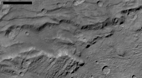 Scientists from NASA's New Horizons mission have spotted signs of long run-out landslides on Pluto's largest moon, Charon. This image is of Charon's informally named Serenity Chasma.