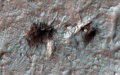 Subtle variations in color look like brush strokes as the lightly frosted terrain reflects light on Mars as seen by NASA's Mars Reconnaissance Orbiter.