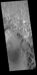 This image from NASA's 2001 Mars Odyssey spacecraft is of an unnamed crater in Terra Sirenum. There are gullies dissecting part of the crater rim, and small dunes on the crater floor.