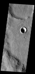 This image from NASA's 2001 Mars Odyssey spacecraft shows the same young crater from earlier this week. In this image we can see how the thin radial ejecta has lapped up and over the ridge at the bottom of the image.