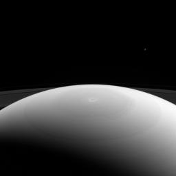 From high above Saturn's northern hemisphere, NASA's Cassini spacecraft gazes over the planet's north pole, with its intriguing hexagon and bullseye-like central vortex.