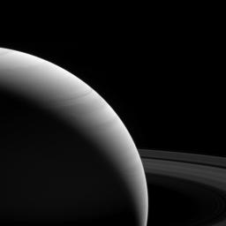The light of a new day on Saturn illuminates the planet's wavy cloud patterns and the smooth arcs of the vast rings as seen by NASA's Cassini spacecraft.