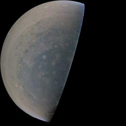 Cyclones swirl around the south pole, and white oval storms can be seen near the limb of Jupiter's south polar region taken by NASA's Juno spacecraft on Feb. 2, 2017.