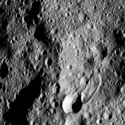 This close-up view of Hakumyi crater, as seen by NASA's Dawn spacecraft, provides insight into the origin of the small crater and lobe-shaped flow next to its southern rim.