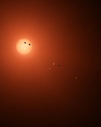 This illustration shows the seven TRAPPIST-1 planets as they might look as viewed from Earth using a fictional, incredibly powerful telescope. The sizes and relative positions are correctly to scale.