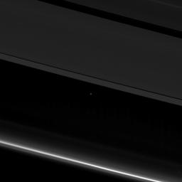 This view from NASA's Cassini spacecraft shows planet Earth as a point of light between the icy rings of Saturn. Cassini was 870 million miles (1.4 billion kilometers) away from Earth when the image was taken.