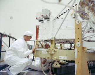 This archival photo shows engineers at NASA's Jet Propulsion Laboratory working on the 10-sided central structure, or 'bus,' of the Voyager 2 spacecraft on February 24,1977.