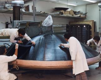 Engineers are engaged in the construction of a high gain antenna for one of NASA's Voyager spacecraft in This archival photo taken on October 29, 1975.