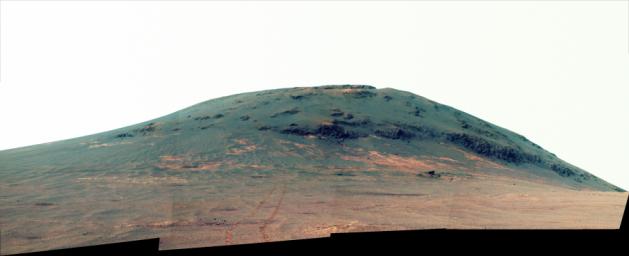 This view enhanced view from NASA's Mars Exploration Rover Opportunity looks back at the southern end of 'Cape Tribulation' from about two football fields' distance away.