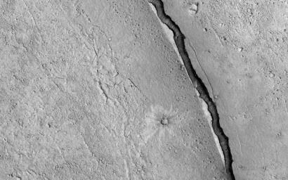 NASA's Mars Reconnaissance Orbiter spies a crater that lies close to Elysium, a major volcanic system on Mars. The whole region surrounding the crater was at some point covered by lava from the volcano creating vast lava plains.