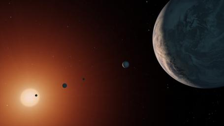 This artist's concept shows what the TRAPPIST-1 planetary system may look like from a vantage point near planet TRAPPIST-1f (at right).