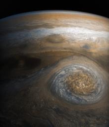 A dynamic storm at the southern edge of Jupiter's northern polar region dominates this Jovian cloudscape, courtesy of NASA's Juno spacecraft.