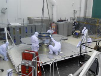 Lockheed Martin spacecraft specialists check the cruise stage of NASA's InSight spacecraft in this June 22, 2017, photo. The cruise stage will provide vital functions during the flight from Earth to Mars.