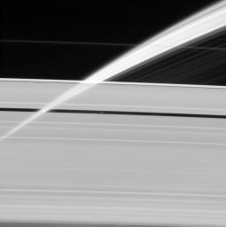 Saturn's rings, made of countless icy particles, form a translucent veil in this view from NASA's Cassini spacecraft. Saturn's tiny moon Pan orbits within the Encke Gap in the A ring.