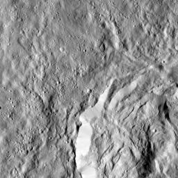 This image obtained by NASA's Dawn spacecraft shows a field of small craters next to Kokopelli Crater, seen at bottom right in this image, on dwarf planet Ceres.